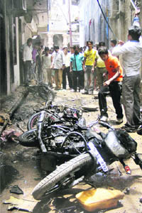 Residents at the blast site in which Uttar Pradesh Minister Nand Gopal Gupta "Nandi" was injured, in Allahabad on Monday.