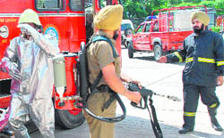 Firemen during a mock drill at Nirman Sadan, Sector 33, Chandigarh, on Tuesday.