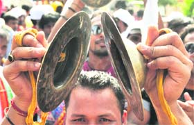 A devotee uses cymbals during Jagannath rath yatra in Ludhiana on Tuesday.