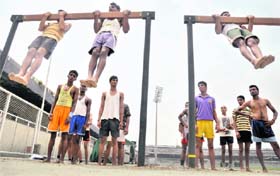 Aspirants do chin-ups during an Army recruitment rally in Ludhiana on Tuesday.