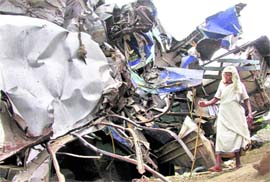 A woman searches for her son amid the mangled remains of the trains that collided in Birbhum district on Monday.