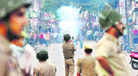 Policemen lob teargas shells on protesters in Samba on Monday. Violent clashes broke out between a mob and the police on the national highway after a person was caught for bovine theft.