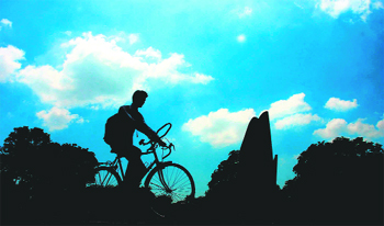 As the sun goes down, a cyclist makes his way through the Leisure Valley in Sector 10.