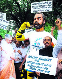 Activists of the Citizen Forum for Commonwealth Games give the Games mascot Shera the face of Suresh Kalmadi, CWG Organising Committee chairman, during a protest in New Delhi on Thursday.