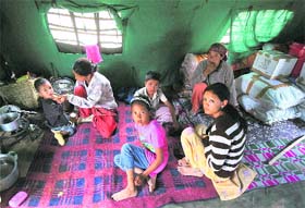 STOPGAP SHELTER: Survivors of the flash floods inside a tent at a relief camp set up by the Army in Choglumsar near Leh