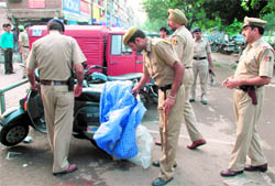 Police personnel check vehicles ahead of Independence Day celebrations at the Sector 22 market in Chandigarh on Saturday