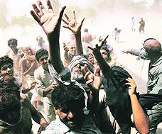Flood survivors jostle for aid as a Pakistan military helicopter delivers relief supplies in an isolated portion of Muzaffargarh district of Punjab on Sunday.