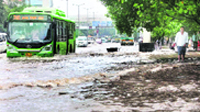 A bus plies on a flooded road near the ITO after heavy rain in New Delhi 