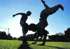 Young boys try out acrobatic movements at Kalagram, Manimajra.