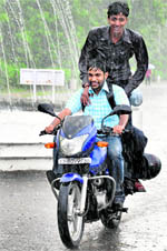 Boys have fun during showers at Panjab University in Chandigarh on Wednesday