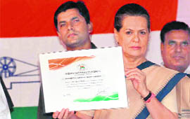 Sonia Gandhi shows her election certificate after she was re-elected Congress president for the fourth consecutive term in New Delhi on Friday.