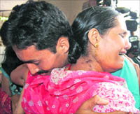 SI Rupesh Sinha hugs his mother after release.