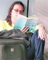 A tourist waits for her flight at the Kolkata airport