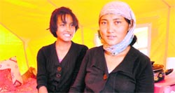 Skalzang Angmo with her mother Stanzin Dolma in their tent at a relief camp in Choglamsar on Thursday.