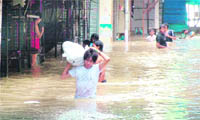 A trader wades through waist-deep water at Monastery, the Tibetan market near the ISBT, in New Delhi 