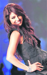 Priyanka Chopra smiles as she poses for a picture during a fashion show in New Delhi on Saturday.