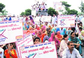 Activists of the Jat Aarakshan Sangharsh Samiti block the GT Road near Hasanpur-Kurar village in Sonepat district