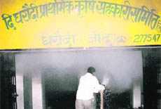 Fire being doused at a mini bank in Darodi village of Jind which was torched by arsonists