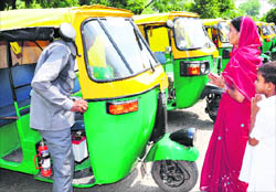 One of the beneficiaries with his family after getting an LPG auto-rickshaw in Chandigarh on Thursday.