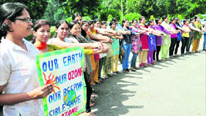 Girls make a human chain on the occasion of World Ozone Day at GCG-11, Chandigarh, on Thursday.