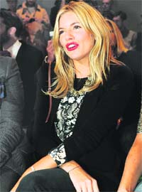 Actor and fashion designer Sienna Miller waits to watch the Matthew Williamson 2011 spring/summer collection during London Fashion Week, recently