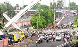 Restoration work in progress after the collapse of an under-construction foot-over bridge near Jawaharlal Nehru Stadium, the main venue for 2010 CWG Games in New Delhi on Tuesday.