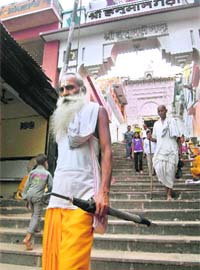 Sadhus go about their spiritual chores at Hanuman Garhi temple close to the disputed Ram Janmabhoomi-Babri Masjid site in Ayodhya