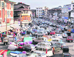 Srinagar private vehicles parked alongside a road as people throng markets to buy essential items during the relaxation of curfew in Srinagar on Saturday.