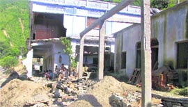 A building damaged due to landslides in Almora.
