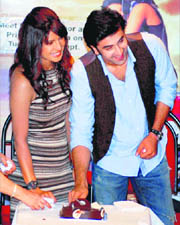 Actors Priyanka Chopra and Ranbir Kapoor cut a cake at a promotional event of their upcoming film Anjaana Anjaani in Mumbai .
