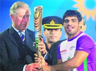 Wrestler Sushil Kumar hands over the Queens Baton to Prince Charles at Jawaharlal Nehru Stadium.