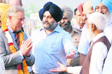 Prince Charles interacts with organic farmer Sukhchain Singh in Hansali village near Fatehgarh Sahib on Monday