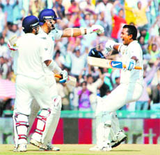 After snatching a victory for India from a no-win situation, VVS Laxman (second from left) celebrates with Suresh Raina and Pragyan Ojha on the final day of the opening India-Australia Test in Mohali on Tuesday.