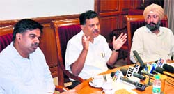 Chief Secretary SC Aggarwal (centre) addresses a press conference in Chandigarh on Friday.