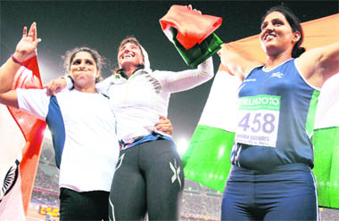 Show Stoppers: (From right) Krishna Poonia, Harwant Kaur and Seema Antil celebrate after winning gold, silver and bronze, respectively, in the discus throw event at the Commonwealth Games in New Delhi on Monday. Poonia's gold is the first in athletics by an Indian after Flying Sikh Milkha Singh's 440-yard race gold in the 1958 edition of the Games in Cardiff, Wales