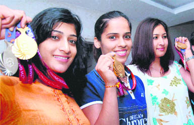 Indias ace shuttlers (from L) Ashwini Ponnapa, Saina Nehwal and Jwala Gutta show their medals at the Gopichand Badminton Academy in Hyderabad on Saturday.