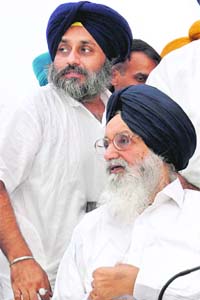 Punjab Chief Minister Parkash Singh Badal and his son Sukhbir Singh Badal at a press conference in Chandigarh