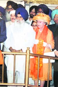 A file photo of Queen Elizabeth at the Golden Temple wearing a hat and a pair of socks