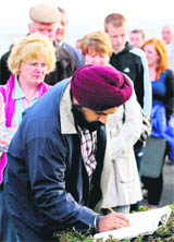 A file photo of a visitor signing the book of condolences for Kanishka victims.