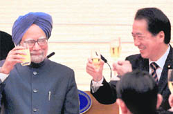 Prime Minister Manmohan Singh raises a toast with his Japanese counterpart Kan Naoto in Tokyo on Monday.