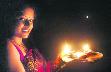 With the moon finally out, a woman readies to worship it on the occasion of  Karva Chauth in Chandigarh 