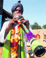 An artiste creates a melodious tune with a traditional Rajasthani been at the National Crafts Mela