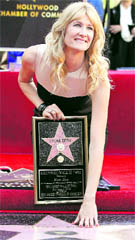 Actor Laura Dern touches her star on the Walk of Fame in Hollywood, California