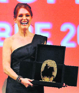 US actor Julianne Moore holds the Marco Aurelio prize during the award ceremony at the Rome Film Festival at Rome's Auditorium on Tuesday.