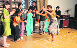 US First Lady Michelle Obama plays with kids during an interaction with those associated with NGO Make A Difference in Mumbai on Saturday.
