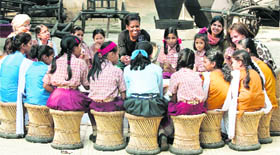 US First Lady Michelle Obama with a group of children during her visit to National Handicrafts and Handlooms Museum (Crafts Museum) in New Delhi on Monday. Michelle is an undisputed hit in India.