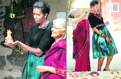 US First Lady Michelle Obama admires handicrafts and tries on a necklace in New Delhi on Monday.