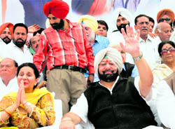 Capt Amarinder Singh, former Punjab Chief Minister, and his wife Preneet Kaur, Minister of State for External Affairs, wave to supporters after he took charge as PPCC president at a mammoth rally at the Punjab Pradesh Congress office in Chandigarh on Friday.