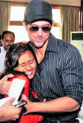 Bollywood actor Hrithik Roshan hugs a fan during a promotional event for his upcoming film Guzarish in Ahmedabad recently