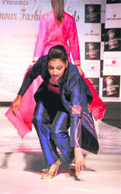A model prevents herself from falling on the ramp at a fashion show organised during the “Dream Weddings” exhibition in Ludhiana on Friday.
